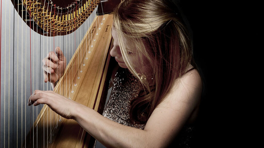 Grace Browning playing her harp.