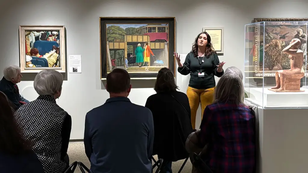Members on an Open MIC tour listening to Curatorial Assistant Lauren Tagliaferro.