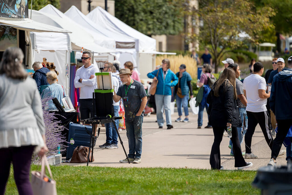 A crowd browsing tents at the 2025 M&T Bank Clothesline Art Festival.