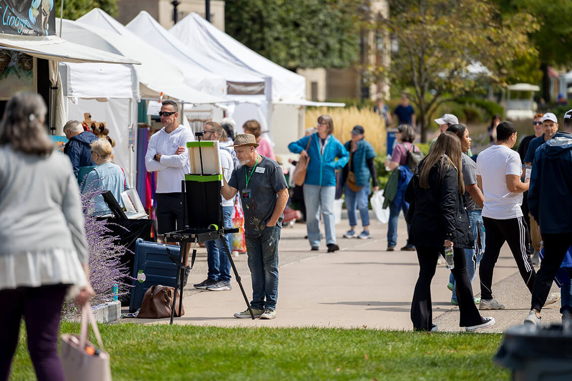 A crowd browsing tents at the 2025 M&T Bank Clothesline Art Festival.