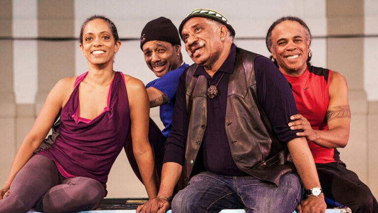 Four members of Garth Fagan Dance posing on stage.