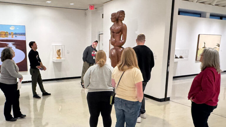 Teachers looking at John Rhoden's sculpture "Generations" at MAG.