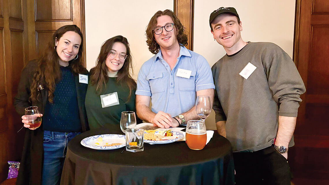 Four people smiling at the camera at a Make a Connection event.
