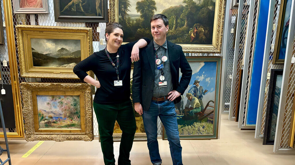 Lauren Tagliaferro and Adam Koneman pose together in MAG's painting storage.