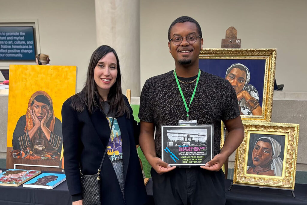 MAG Director Sarah Jesse stands next to Unique Fair-Smith, a 2025 award winner.