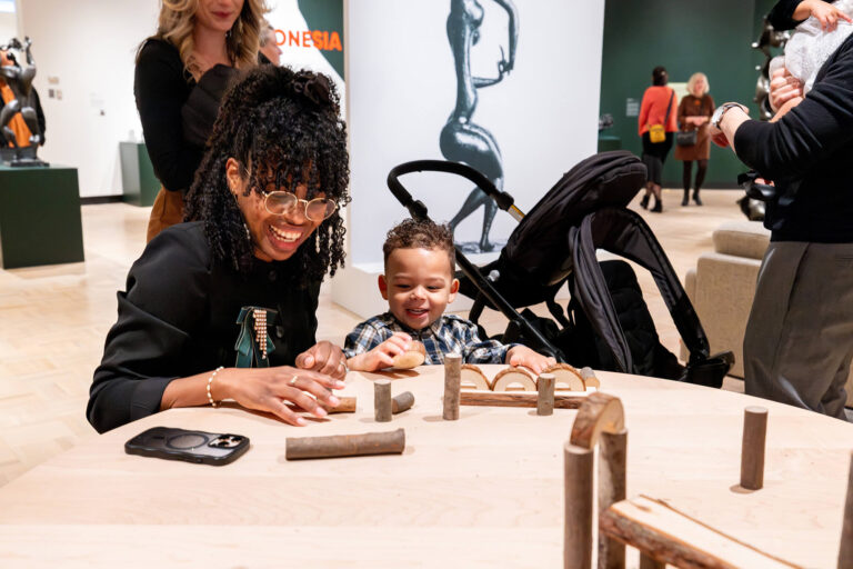 A parent and child work on an art activity together at MAG.