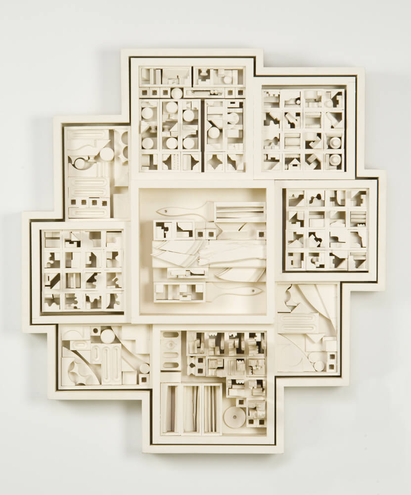 Sculpture of a drawer turned on its side, the components transformed into a city-like relief.
