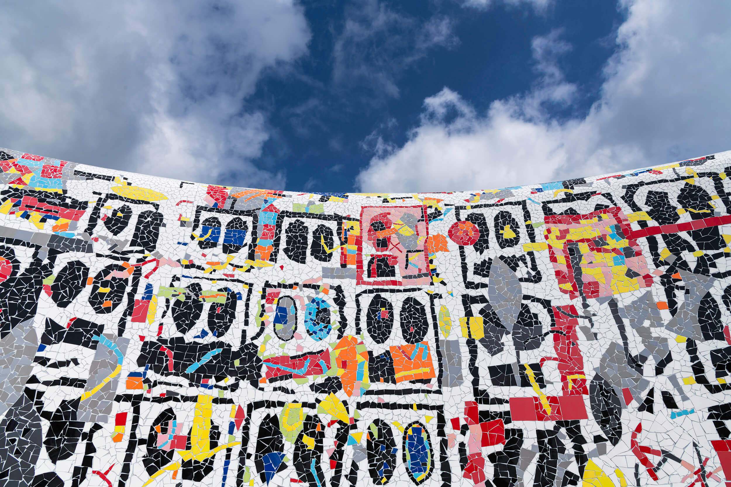 A section of Rashid Johnson's "Broken Pavilion," showing the abstract mosaic faces on the wall.