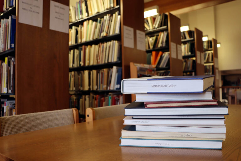 A stack of books on one of the tables in MAG's library.