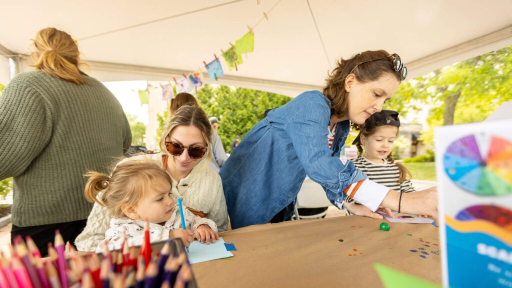Parents and children making art together.