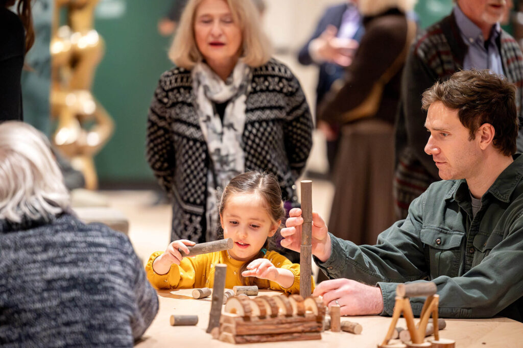 A father and daughter building with blocks in a Docent Gallery exhibition engagement area.