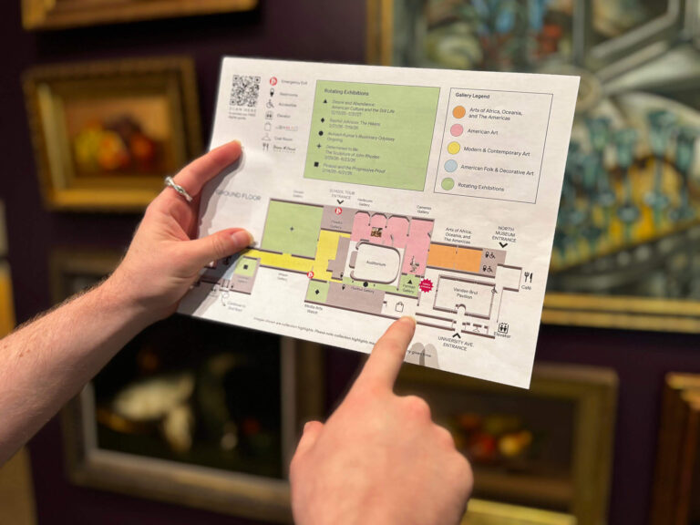 A person using MAG's museum map in the galleries.