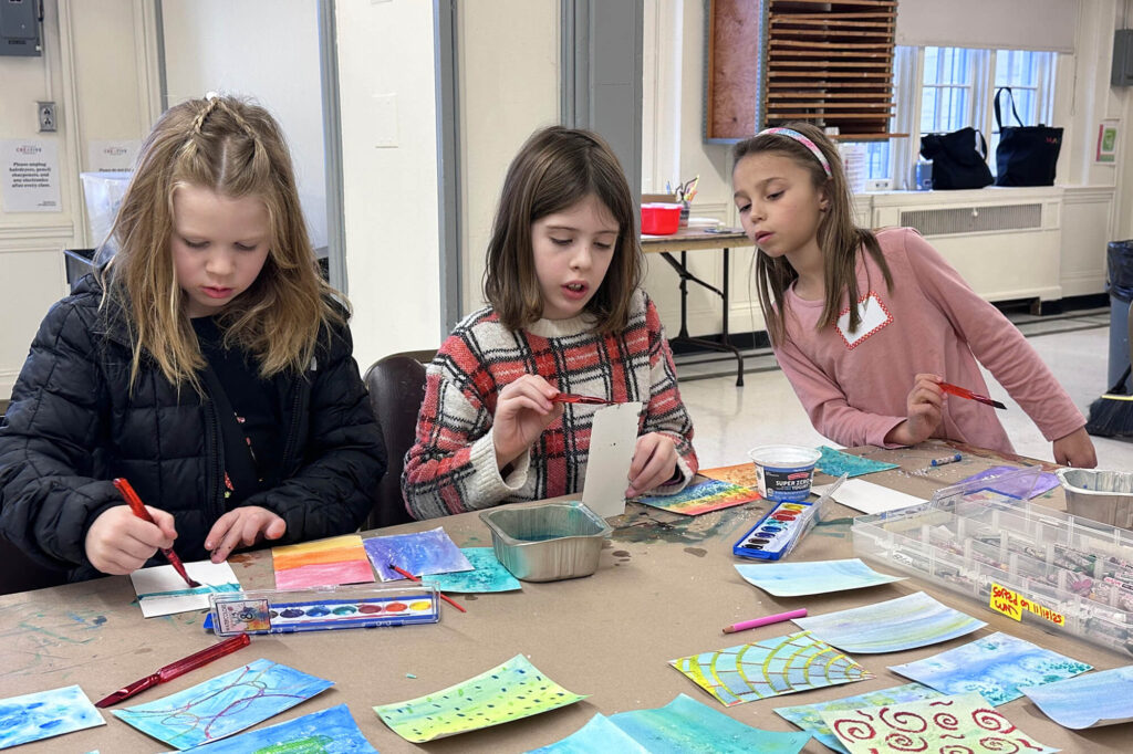 Campers paint watercolors in the Creative Workshop.