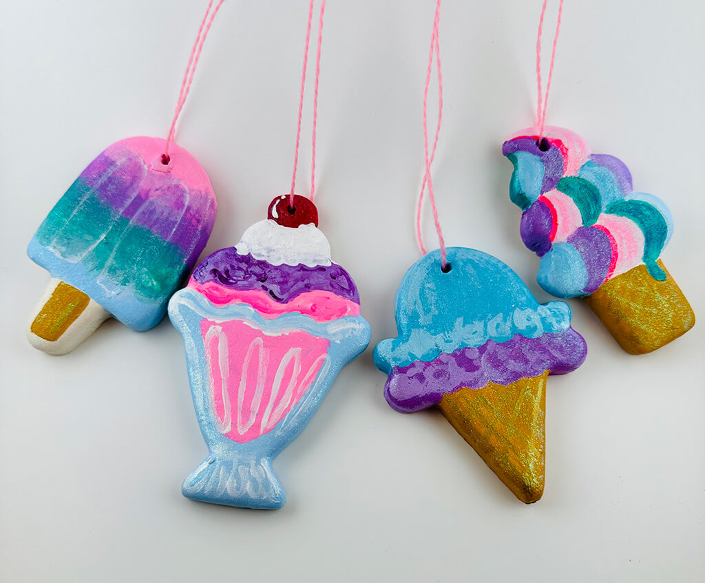 Four ceramic ornaments painted in bright colors and shaped like different kinds of ice cream.