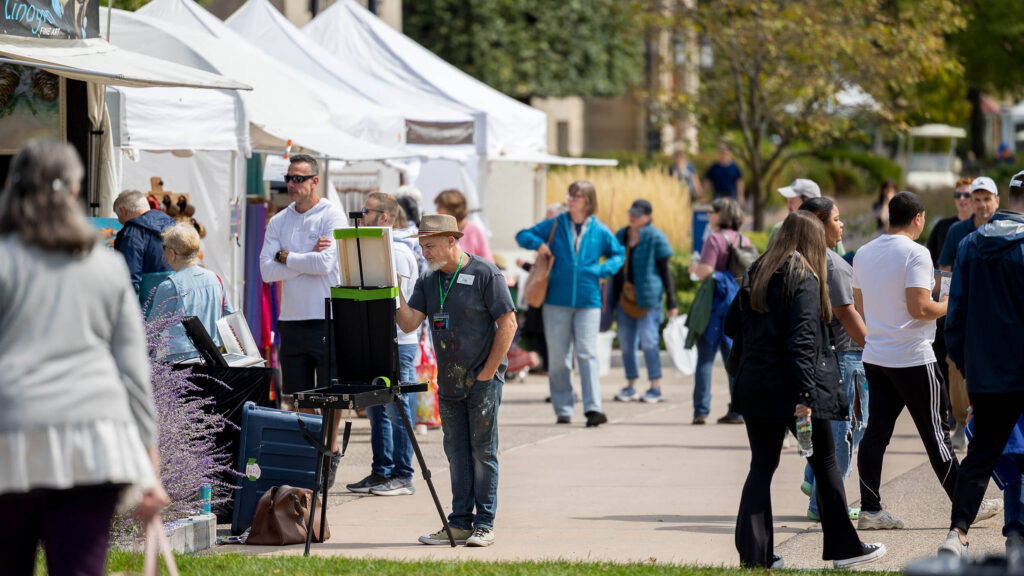 A crowd browsing tents at the 2025 M&T Bank Clothesline Art Festival.