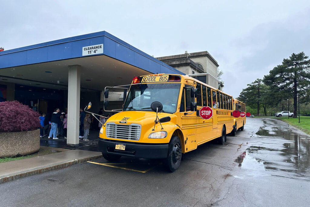 A school bus pulled up to the tour entrance at MAG, students getting off to go inside the museum.
