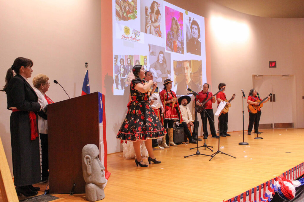 Performers on stage in MAG's auditorium.