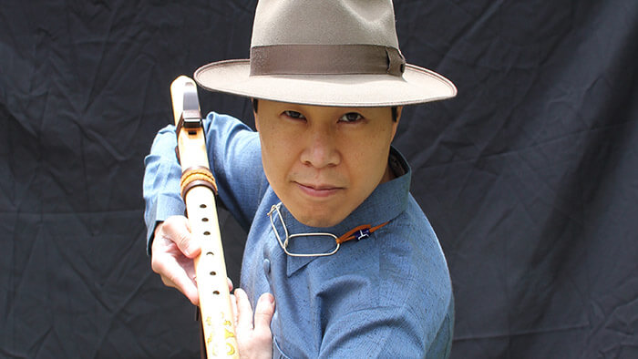 Jefferson Svengsouk holding a Native American flute.