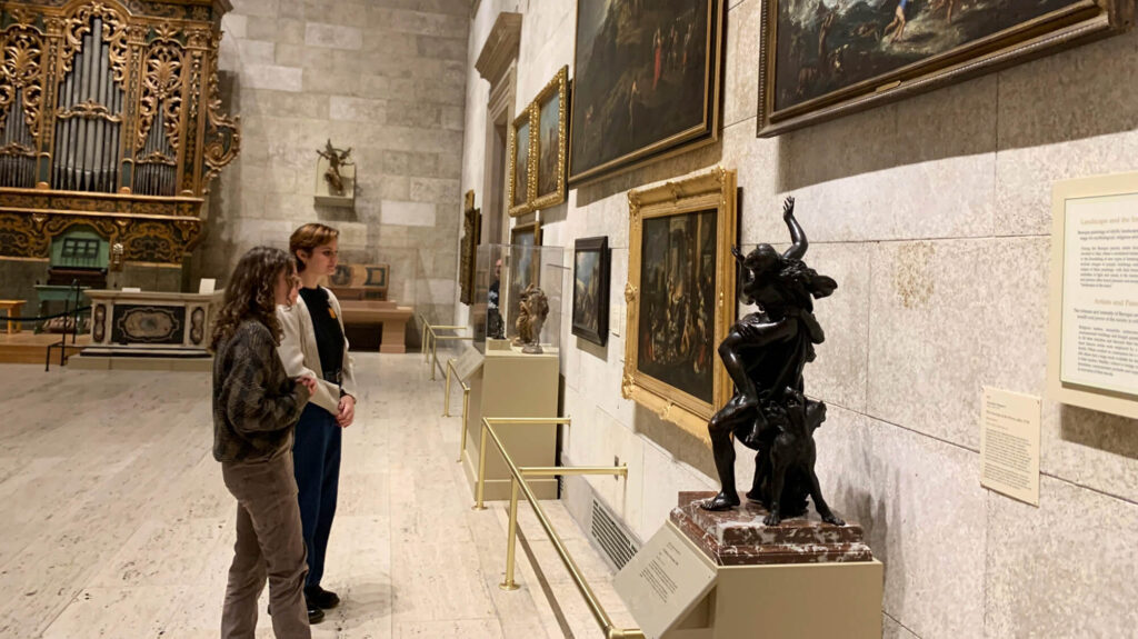 Two visitors look at art in MAG's Fountain Court.