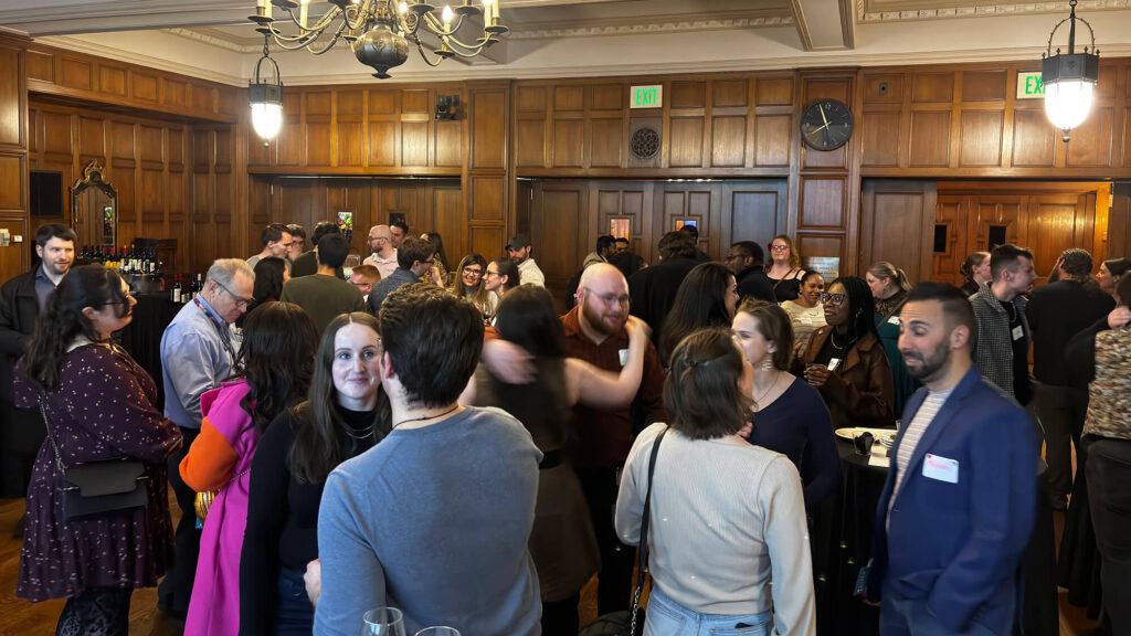 People mingling in the Bausch & Lomb Parlor.