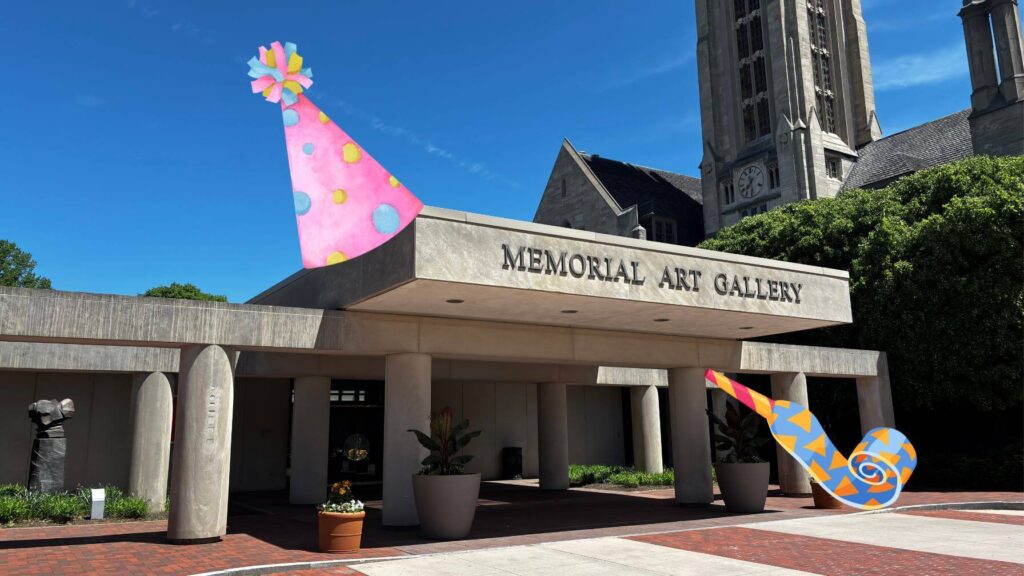 The entrance to MAG, with a party hat and horn edited on top of it.