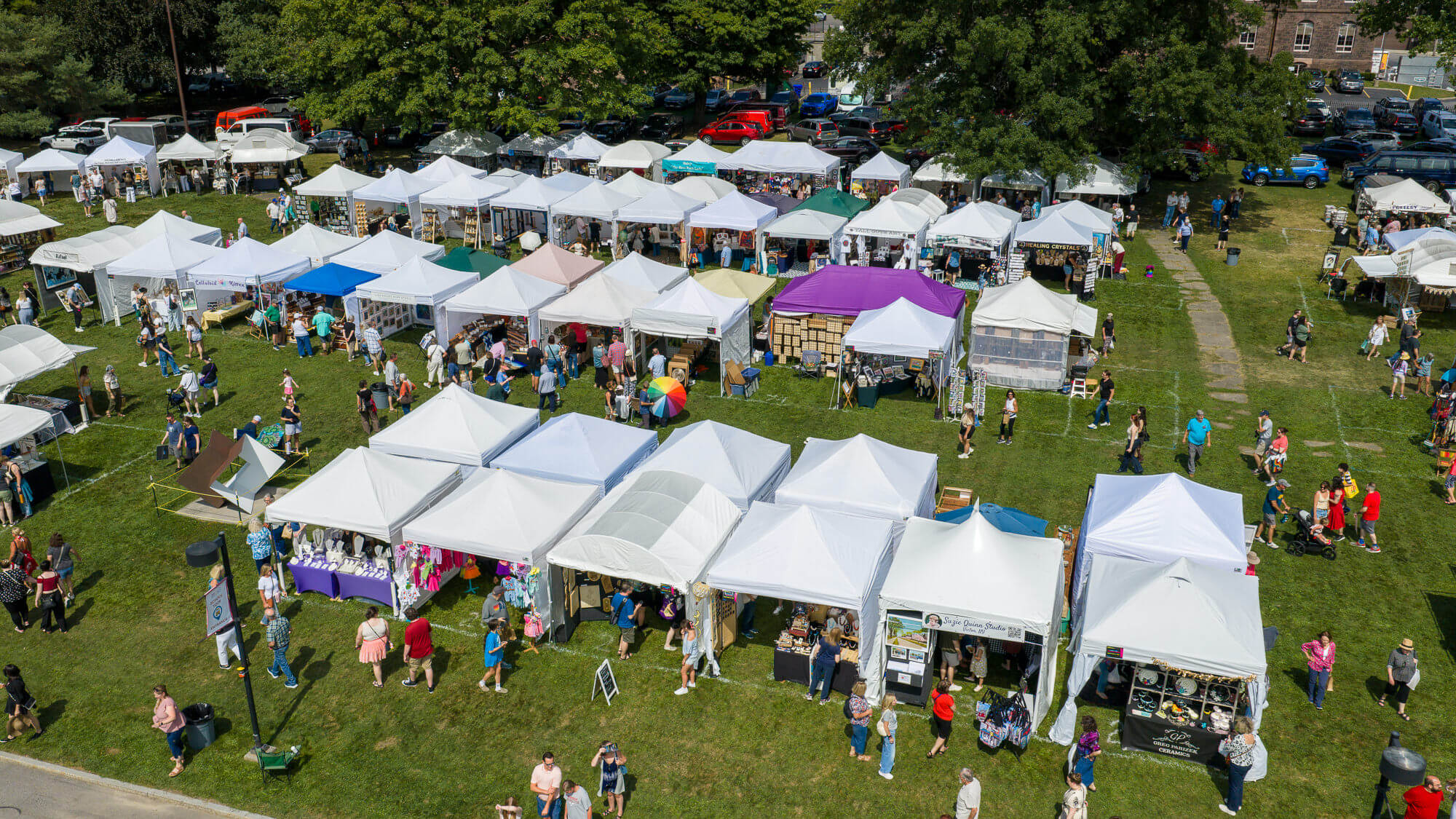 Overhead view of artist booths lining MAG's back lawn.